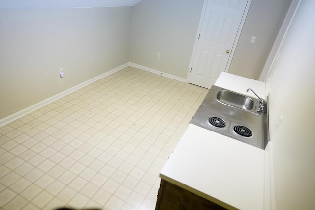 kitchen featuring a sink and baseboards