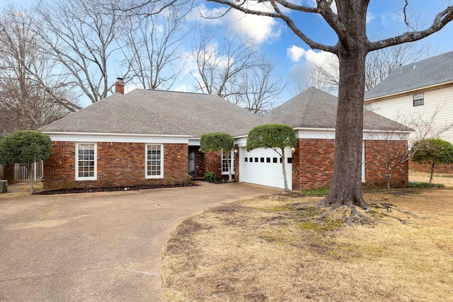 view of front of house with an attached garage, brick siding, concrete driveway, roof with shingles, and a chimney