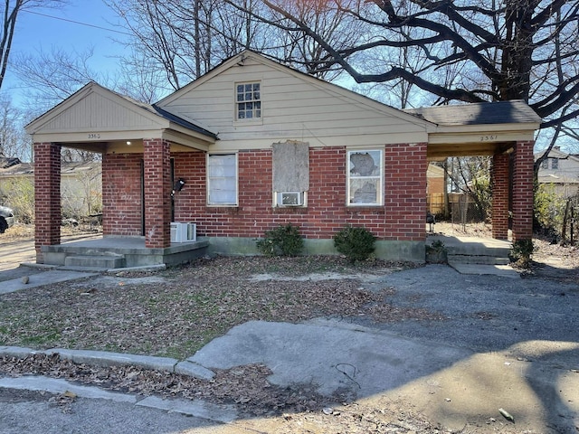 bungalow-style home with brick siding