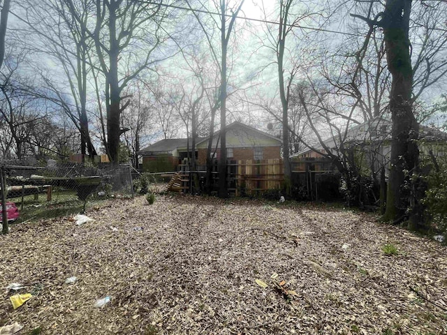 view of yard with a deck and fence