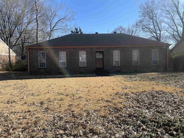 view of front of home featuring brick siding and crawl space