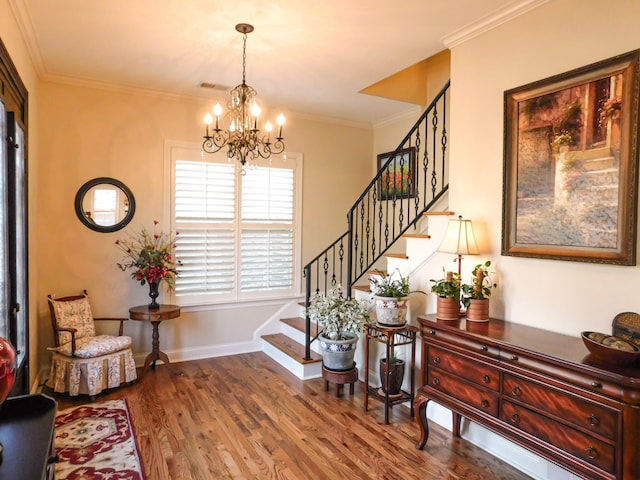 entrance foyer with stairs, baseboards, wood finished floors, and crown molding