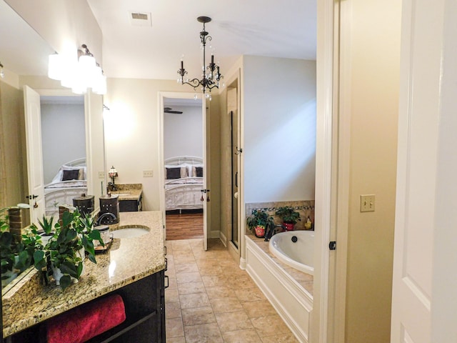 ensuite bathroom with a garden tub, visible vents, ensuite bath, and vanity