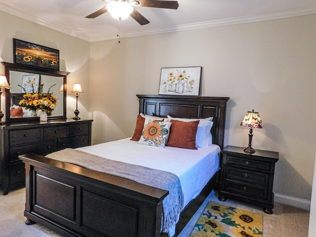 bedroom with baseboards, ornamental molding, a ceiling fan, and light colored carpet