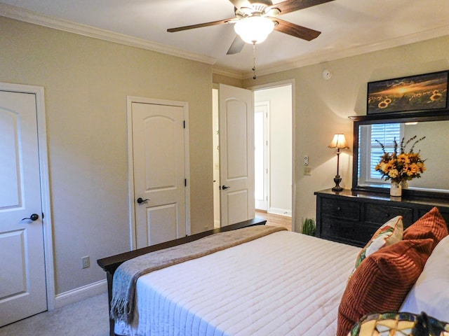 bedroom featuring ceiling fan, baseboards, and crown molding