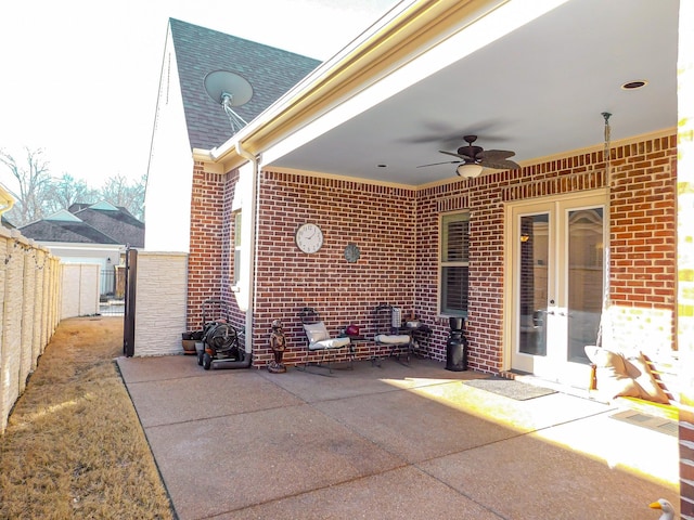 view of patio / terrace featuring french doors, fence, and ceiling fan