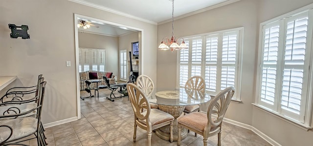 dining room featuring a wealth of natural light, crown molding, baseboards, and light tile patterned floors