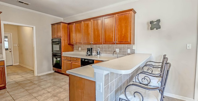 kitchen featuring black appliances, visible vents, decorative backsplash, and light countertops