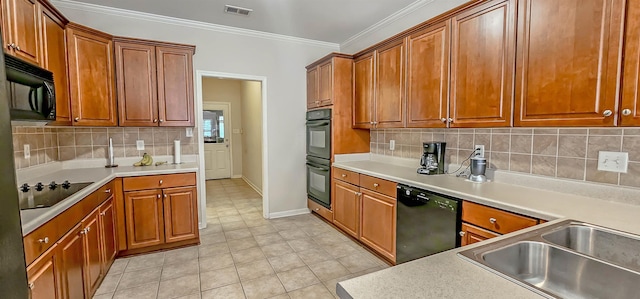 kitchen with visible vents, light countertops, ornamental molding, black appliances, and brown cabinetry