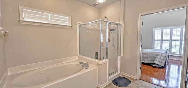 ensuite bathroom featuring visible vents, a stall shower, connected bathroom, a whirlpool tub, and tile patterned floors