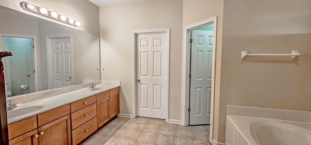 bathroom featuring double vanity, a garden tub, tile patterned flooring, and a sink