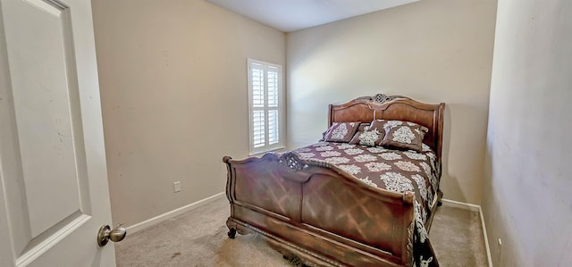 bedroom with carpet floors and baseboards