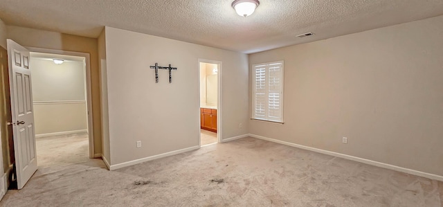 unfurnished bedroom with light carpet, visible vents, and baseboards