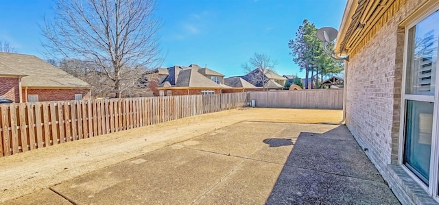 view of patio featuring a fenced backyard and a residential view