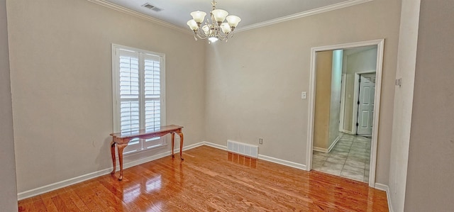 unfurnished dining area with a notable chandelier, visible vents, wood finished floors, and ornamental molding