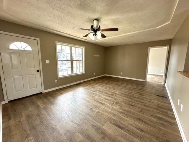 foyer with baseboards, a textured ceiling, a ceiling fan, and dark wood-style flooring