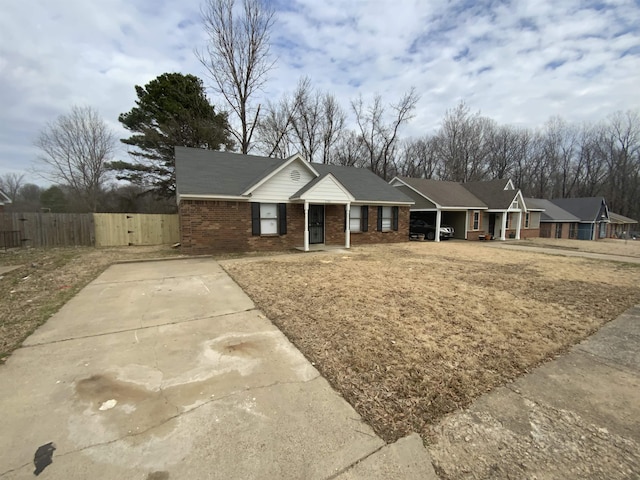 ranch-style house with brick siding and fence