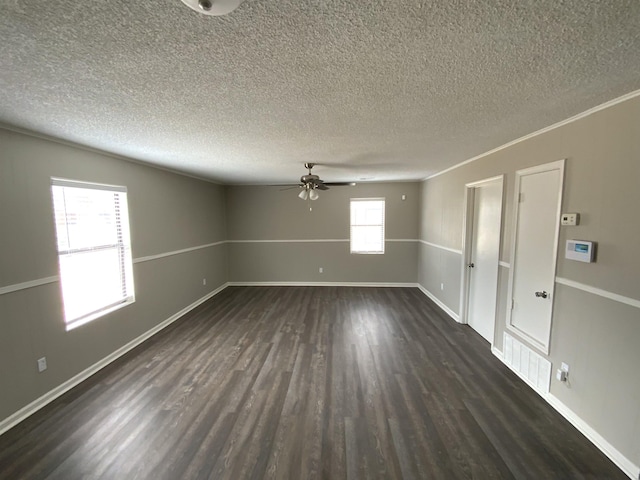 empty room featuring dark wood-style floors, ceiling fan, baseboards, and a textured ceiling