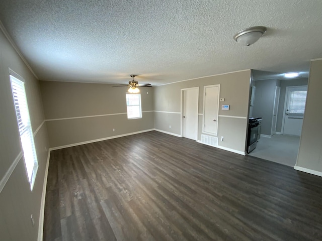 spare room featuring ceiling fan, a textured ceiling, visible vents, and dark wood-type flooring