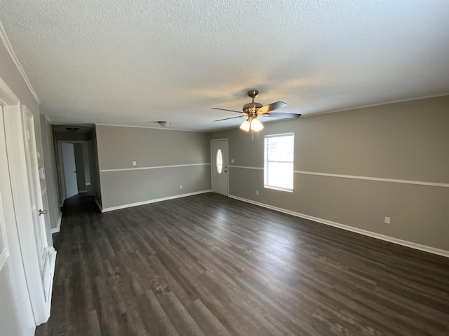 empty room featuring dark wood-style floors, ceiling fan, a textured ceiling, and baseboards