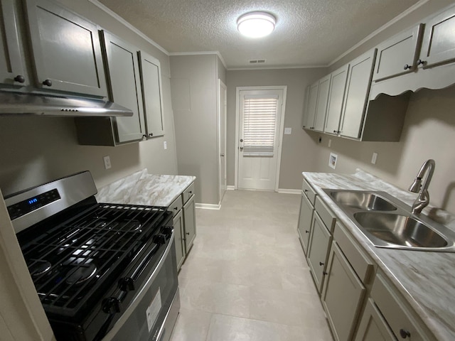 kitchen with stainless steel range with gas cooktop, light countertops, visible vents, a sink, and under cabinet range hood