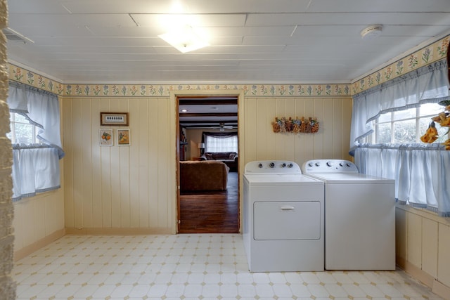 laundry room featuring laundry area, plenty of natural light, washer and clothes dryer, and light floors