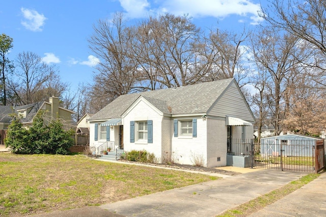 bungalow featuring a shingled roof, crawl space, a gate, a front lawn, and brick siding