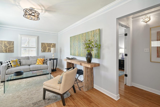 living room featuring crown molding, baseboards, and wood finished floors