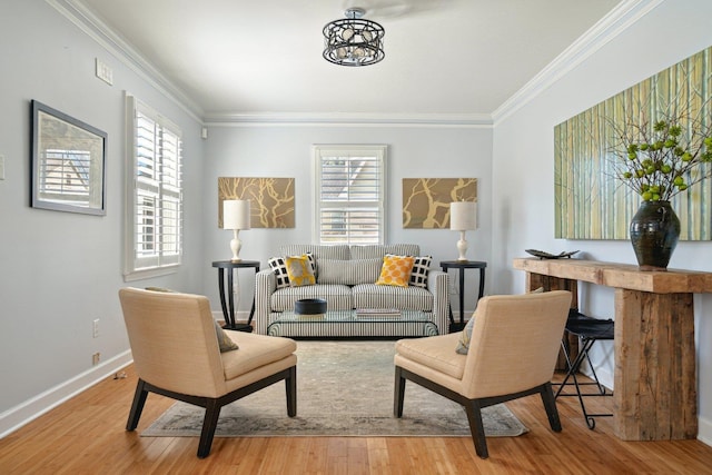 living area featuring baseboards, plenty of natural light, wood finished floors, and crown molding