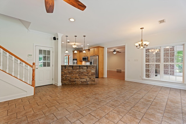 unfurnished living room featuring stairs, visible vents, crown molding, and ceiling fan with notable chandelier