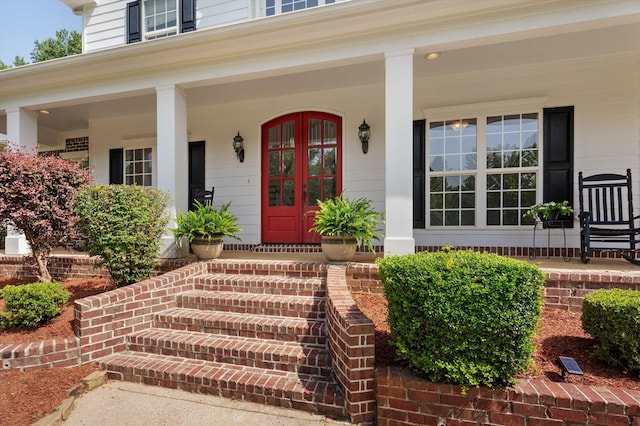 doorway to property with covered porch and french doors