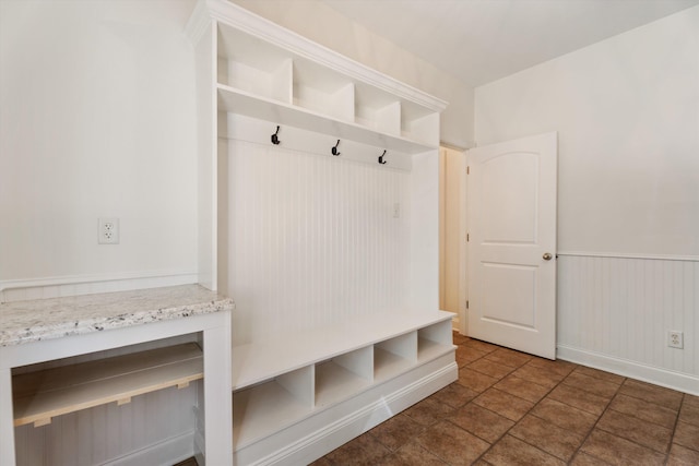 mudroom with a wainscoted wall