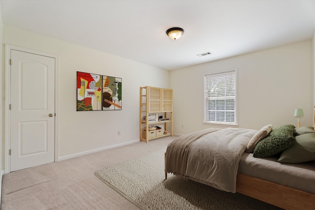 carpeted bedroom with visible vents and baseboards