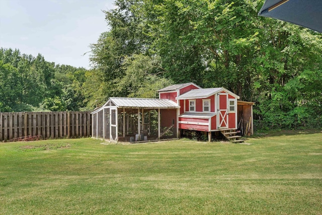 view of poultry coop with a yard and fence