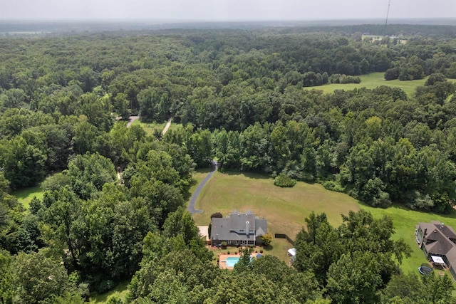 birds eye view of property featuring a wooded view