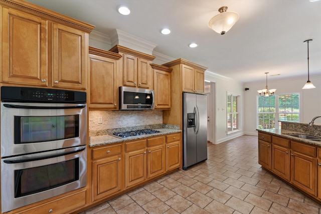 kitchen with stainless steel appliances, a sink, ornamental molding, decorative backsplash, and light stone countertops