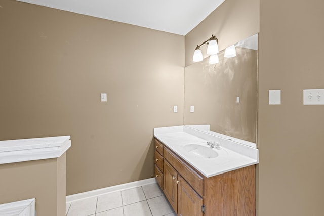 bathroom featuring tile patterned flooring, baseboards, and vanity