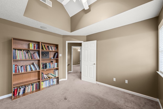 interior space featuring ceiling fan, carpet floors, visible vents, and baseboards