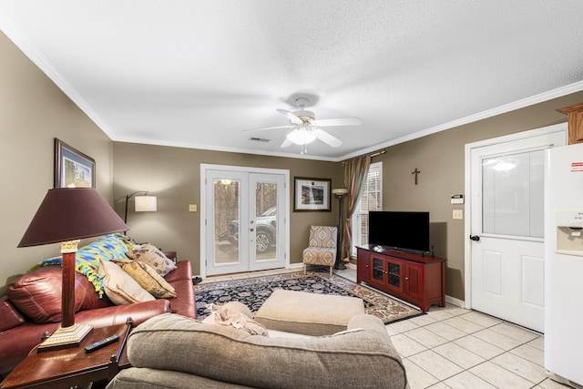 living area with ornamental molding, french doors, ceiling fan, and light tile patterned floors