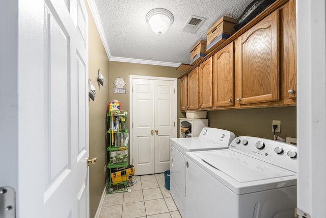 laundry room with light tile patterned floors, cabinet space, visible vents, a textured ceiling, and independent washer and dryer