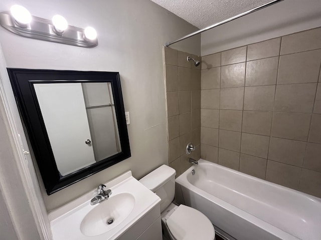 full bath featuring a textured ceiling, shower / bath combination, vanity, and toilet