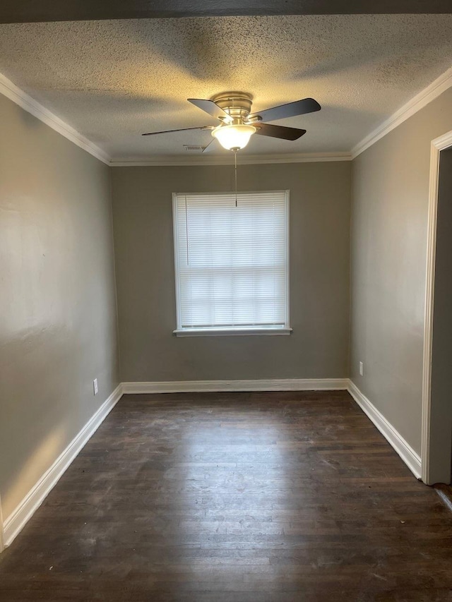 empty room with ornamental molding, dark wood-style flooring, visible vents, and baseboards