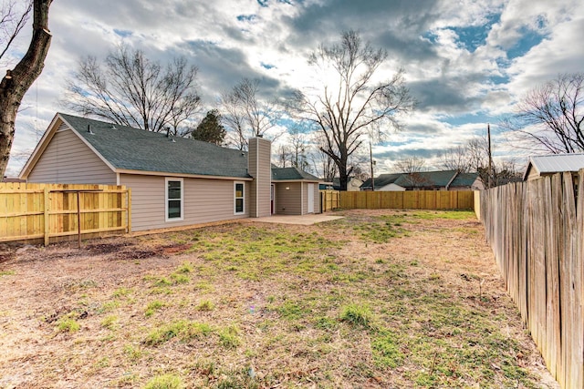 view of yard with a patio and a fenced backyard