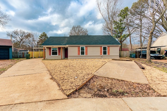 ranch-style house featuring brick siding, a shingled roof, and fence