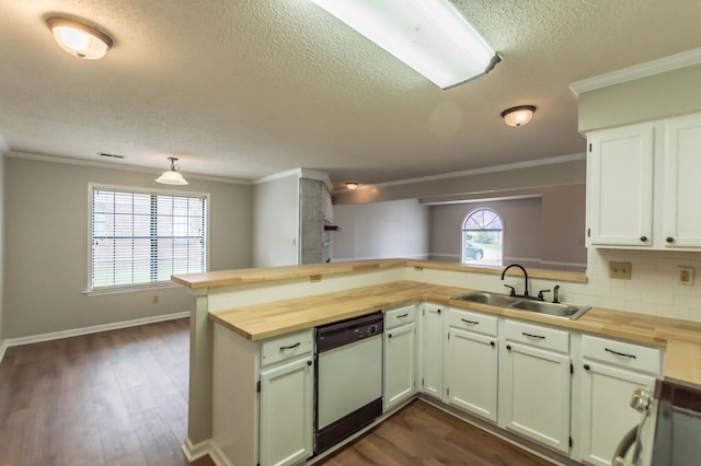 kitchen with a sink, dishwashing machine, wood counters, and range