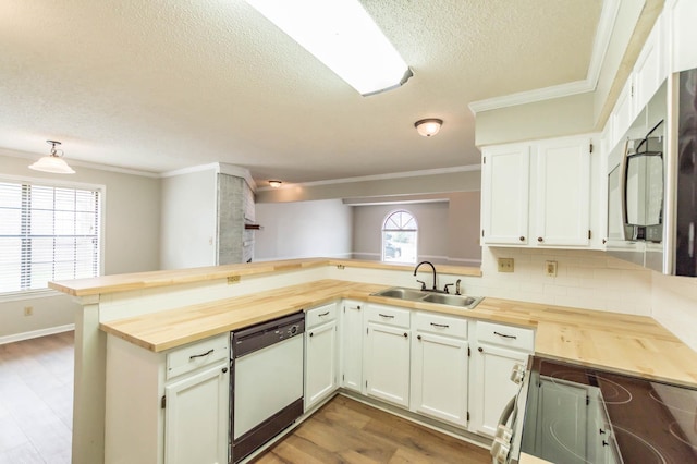 kitchen featuring electric range, white dishwasher, wood counters, and a sink