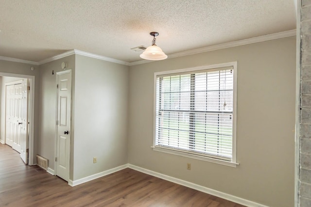 unfurnished room with baseboards, dark wood finished floors, and crown molding