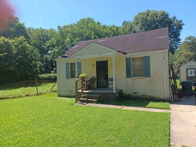 bungalow with crawl space, fence, a front lawn, and brick siding