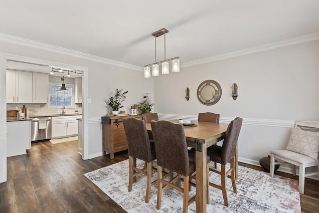 dining space featuring baseboards, dark wood-style flooring, and crown molding