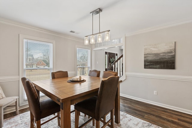 dining space with dark wood-style floors, baseboards, visible vents, and ornamental molding